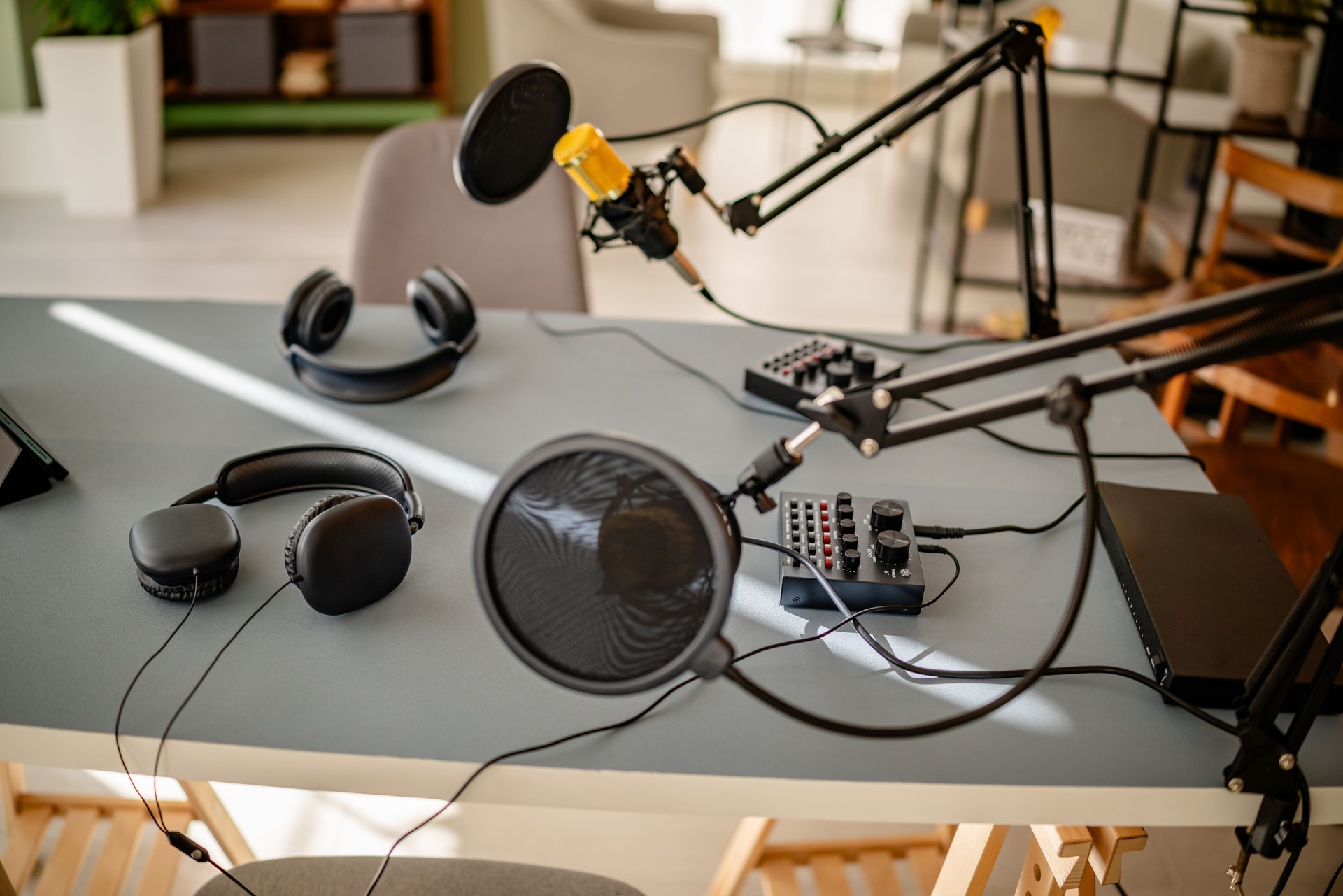 Podcasting setup featuring sound recording equipment in a creative studio space for live broadcasting and interviews with cheerful teamwork